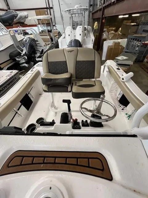Slide: The Image of 2021 Tidewater 220 CC Adventure boat interior with dual seats and steering wheel. - 9