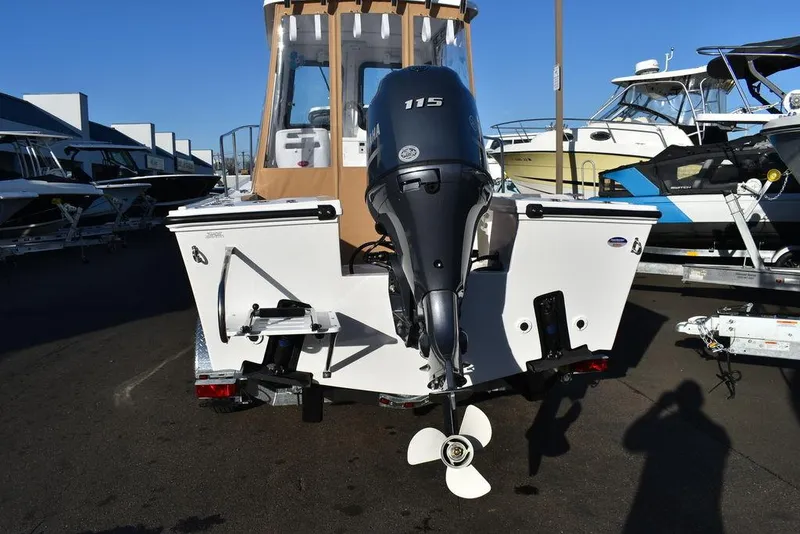 Slide: The Image of 2025 Steiger Craft 21 Peconic boat with outboard motor, docked at marina. - 10