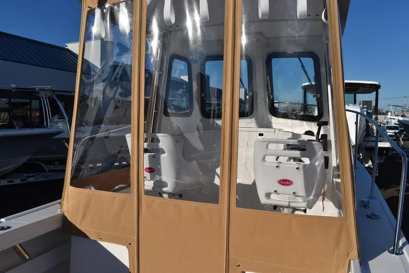 Slide: The Image of 2025 Steiger Craft 21 Peconic boat with enclosed cabin and clear windows. - 31