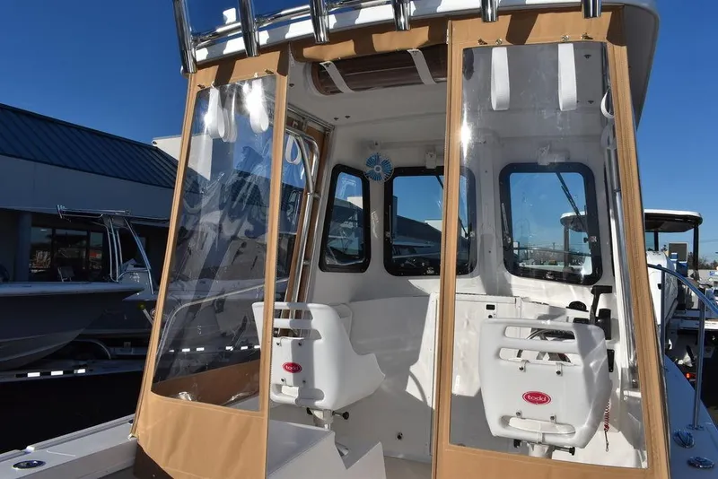 Slide: The Image of 2025 Steiger Craft 21 Peconic boat interior with clear panels and seating. - 33