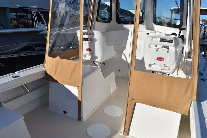 Slide: The Image of 2025 Steiger Craft 21 Peconic boat interior with seating and protective covers. - 34