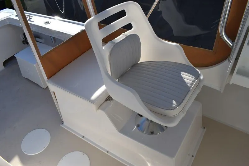 Slide: The Image of 2025 Steiger Craft 21 Peconic boat seat with white cushioned design. - 37