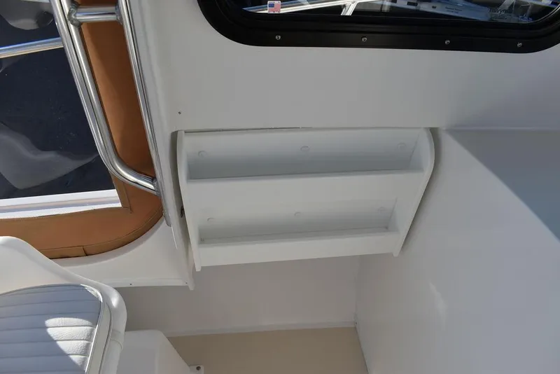 Slide: The Image of Interior of 2025 Steiger Craft 21 Peconic boat, featuring white shelving and seating. - 38