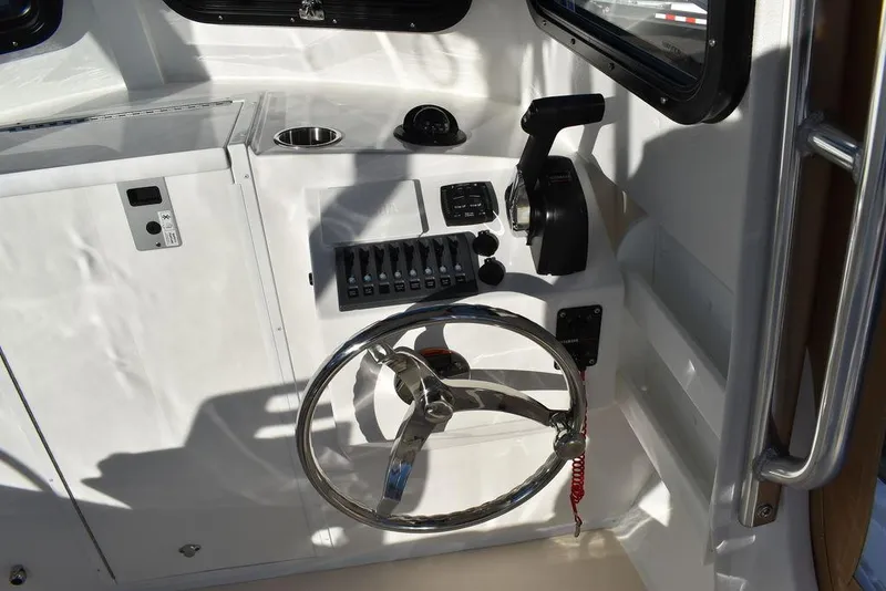 Slide: The Image of Steiger Craft 21 Peconic 2025 boat helm with steering wheel and controls. - 41
