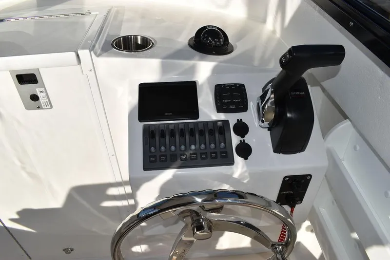Slide: The Image of Steiger Craft 21 Peconic 2025 boat dashboard with steering wheel and controls. - 42