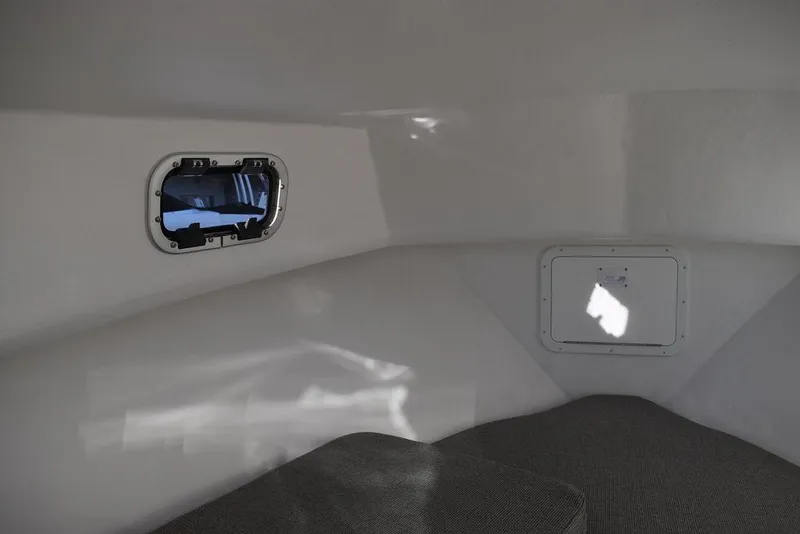 Slide: The Image of Interior cabin of 2025 Steiger Craft 21 Peconic boat, featuring a small window. - 47