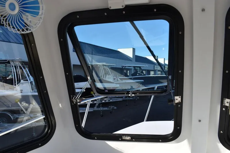 Slide: The Image of View from inside a 2025 Steiger Craft 21 Peconic boat, showcasing marina and other boats. - 49