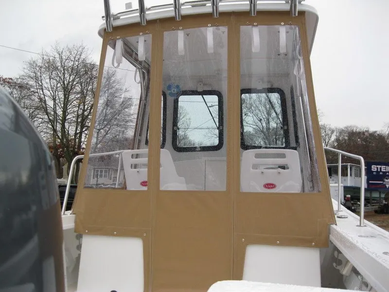 Slide: The Image of 2025 Steiger Craft 21 Peconic boat with enclosed cabin, beige and white design. - 5