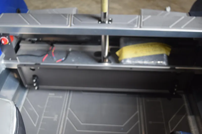 Slide: The Image of 2024 Stabicraft 1550 Frontier SportFish interior with storage compartment and wiring. - 11