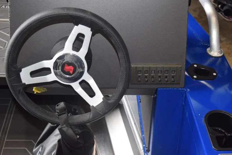 Slide: The Image of 2024 Stabicraft 1550 Frontier SportFish steering wheel and control panel. - 13