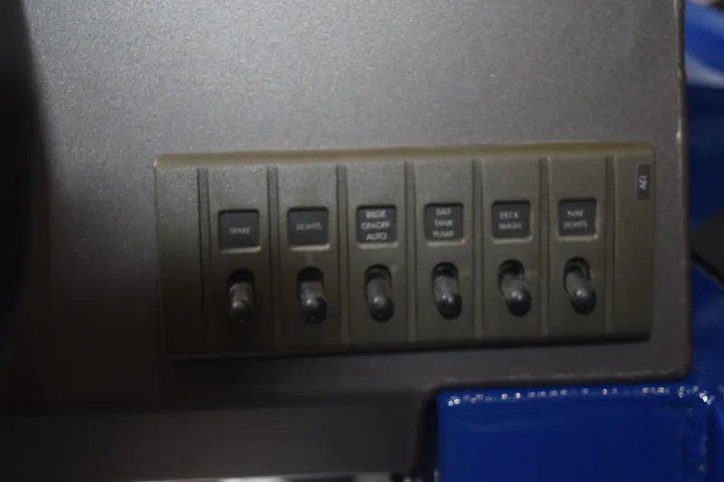 Slide: The Image of Control panel of 2024 Stabicraft 1550 Frontier SportFish boat with labeled switches. - 14