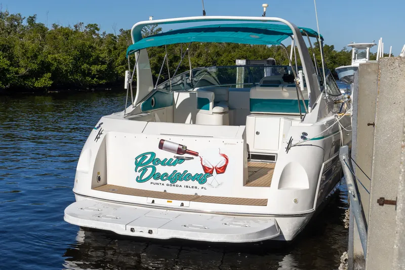 Slide: The Image of 1995 Cruisers Esprit 3570 boat docked, featuring "Boat Decisions" signage. - 2