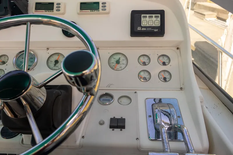 Slide: The Image of 1995 Cruisers Esprit 3570 boat dashboard with steering wheel and gauges. - 20