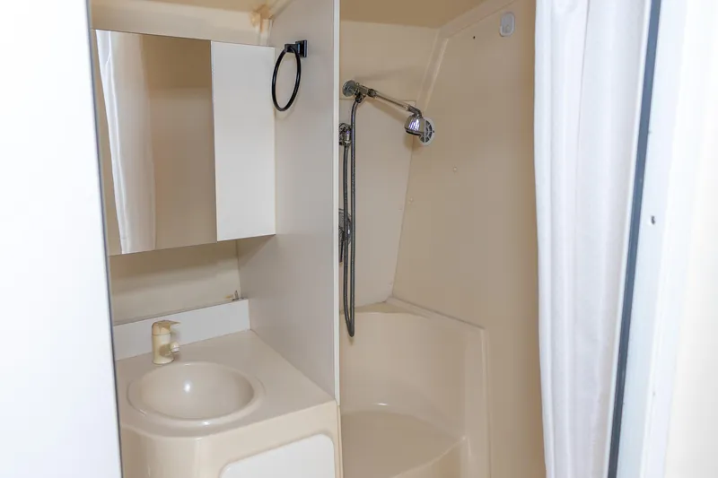 Slide: The Image of 1995 Cruisers Esprit 3570 bathroom with sink, mirror, and shower. - 36