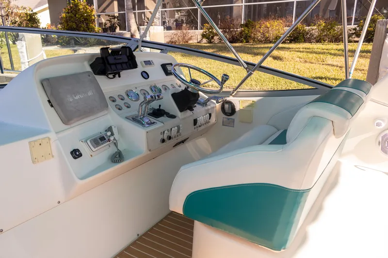 Slide: The Image of 1995 Cruisers Esprit 3570 boat cockpit with steering wheel and control panel. - 7