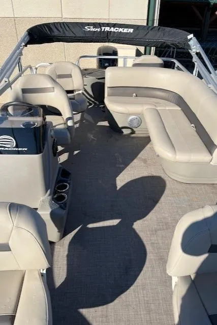 Slide: The Image of 2022 Sun Tracker Bass Buggy 18 DLX pontoon boat interior with beige seating. - 4