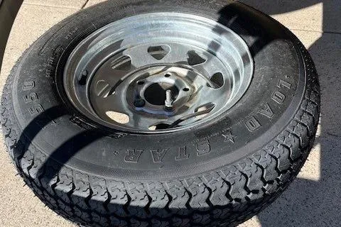 Slide: The Image of Spare tire for 2022 Sun Tracker Bass Buggy 18 DLX on concrete surface. - 7