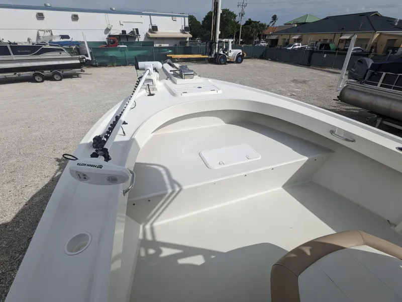 Slide: The Image of 2019 Parker 2500 SE Center Console boat in a marina, showcasing spacious deck and seating. - 16