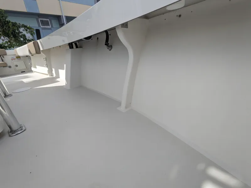 Slide: The Image of 2019 Parker 2500 SE Center Console boat interior, showcasing clean white deck and structure. - 17