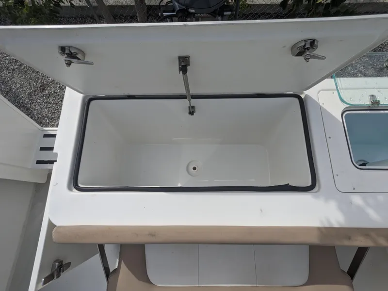 Slide: The Image of Open storage compartment on 2019 Parker 2500 SE Center Console boat. - 5