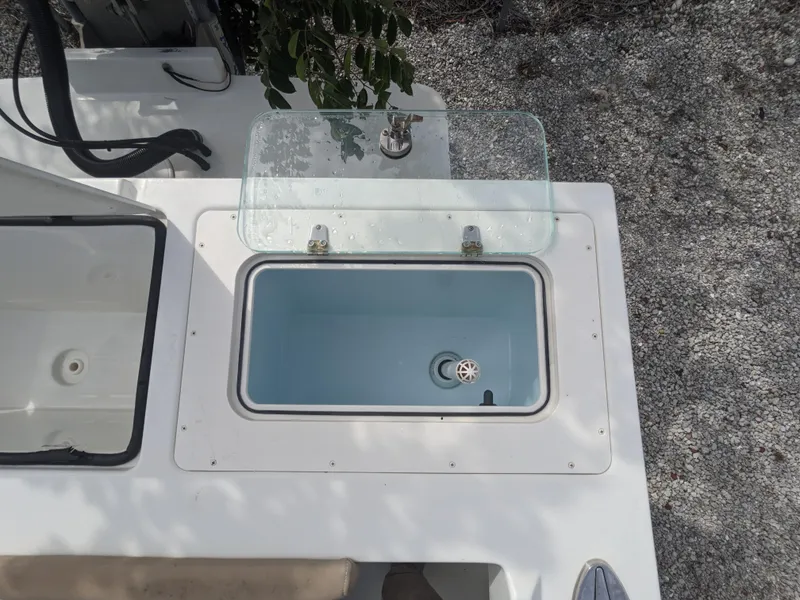 Slide: The Image of 2019 Parker 2500 SE Center Console boat with open livewell on deck. - 6