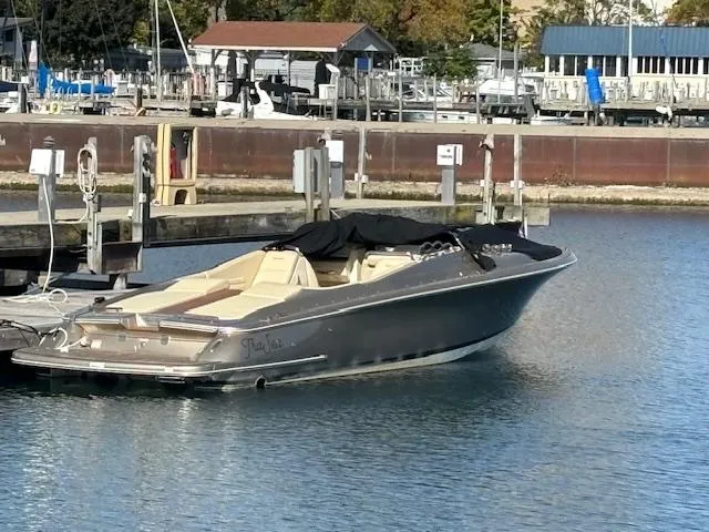 Slide: The Image of 2014 Chris-Craft Launch 32 docked in a serene marina setting. - 1