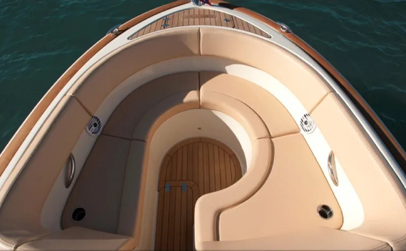 Slide: The Image of 2014 Chris-Craft Launch 32 interior with beige seating and wooden flooring. - 11