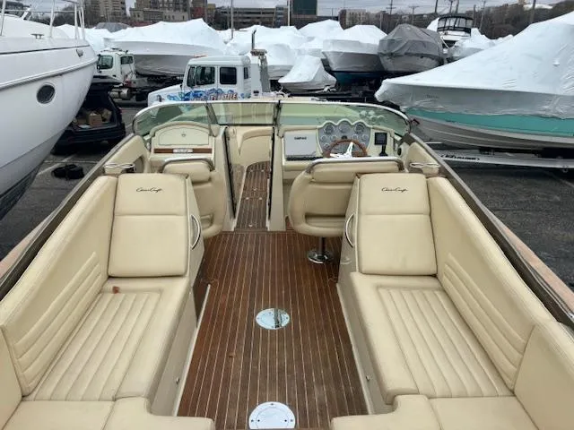 Slide: The Image of 2014 Chris-Craft Launch 32 boat with beige seating and wooden deck, docked outdoors. - 2