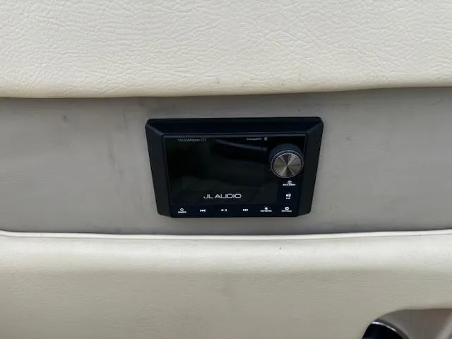 Slide: The Image of 2014 Chris-Craft Launch 32 boat seat with beige upholstery and wooden accents. - 22