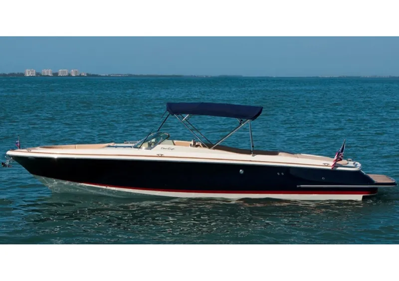 Slide: The Image of 2014 Chris-Craft Launch 32 boat with covered deck on trailer in marina. - 9