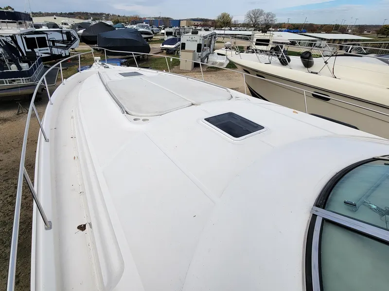 Slide: The Image of 2000 Sea Ray 460 Sundancer yacht on display at a marina. - 12