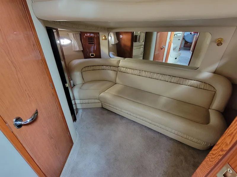 Slide: The Image of Interior of 2000 Sea Ray 460 Sundancer yacht with beige leather seating. - 25
