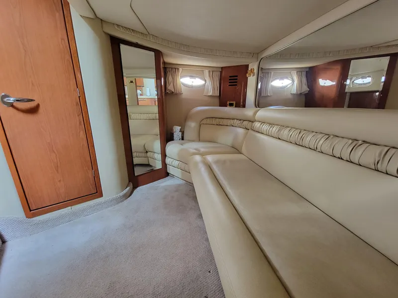 Slide: The Image of Interior of 2000 Sea Ray 460 Sundancer with beige leather seating and wood accents. - 27