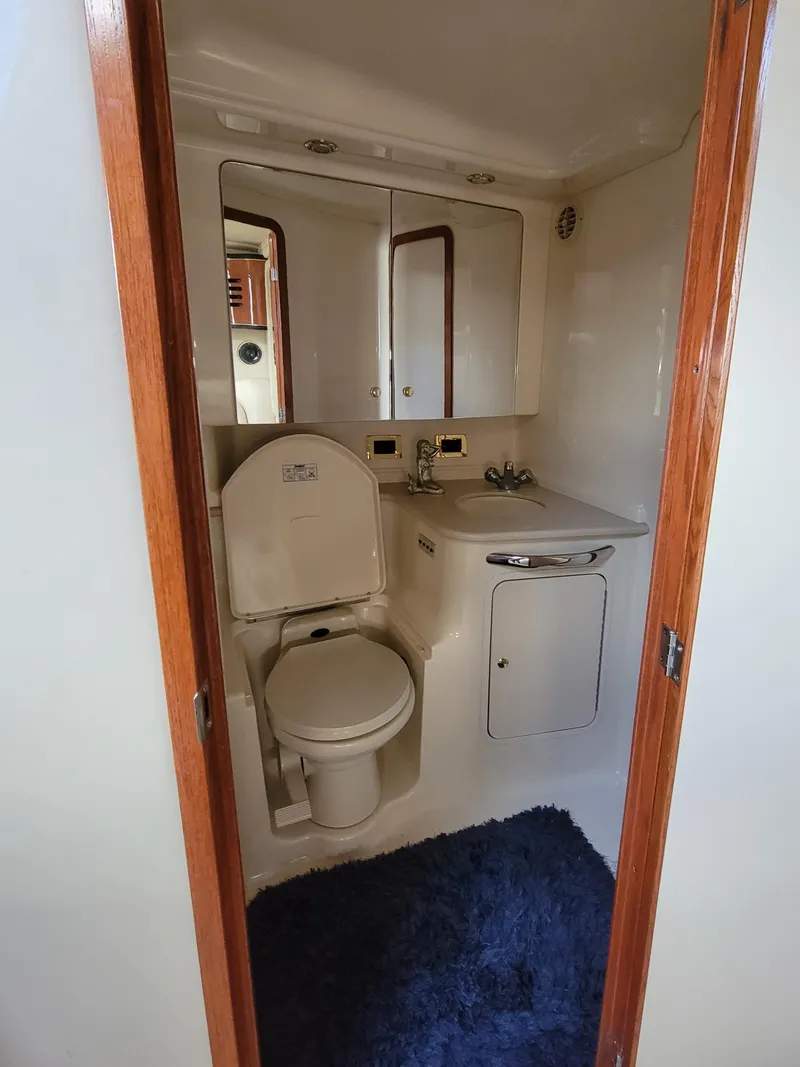 Slide: The Image of Bathroom interior of 2000 Sea Ray 460 Sundancer yacht, featuring toilet and sink. - 35