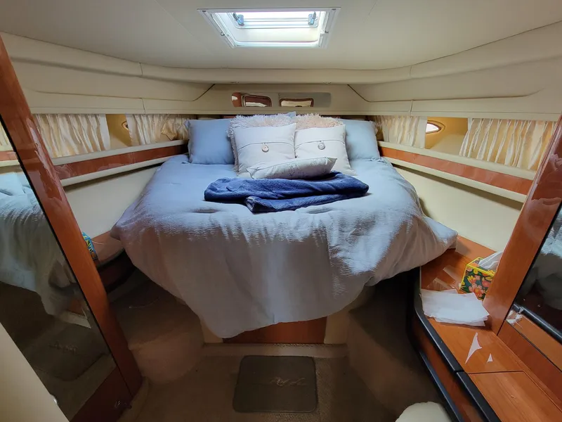 Slide: The Image of Cozy bedroom in 2000 Sea Ray 460 Sundancer yacht with skylight and plush bedding. - 38