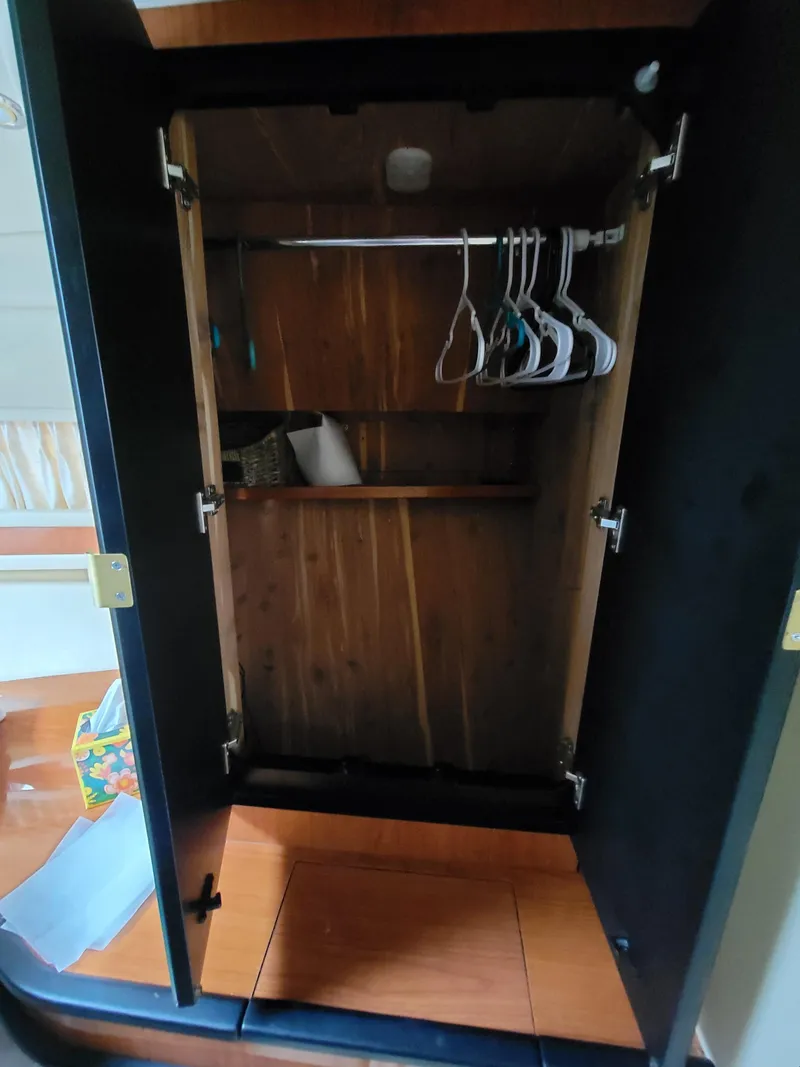 Slide: The Image of Empty wooden closet with hangers inside a 2000 Sea Ray 460 Sundancer yacht. - 42