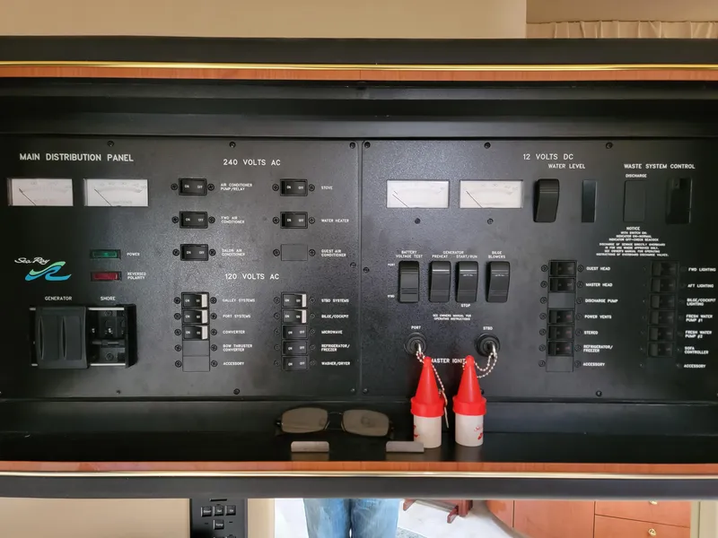 Slide: The Image of Control panel of a 2000 Sea Ray 460 Sundancer yacht, featuring various switches and gauges. - 44