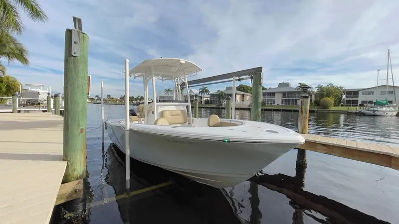 Slide: The Image of 2018 Sportsman Open 212 boat docked at a marina, calm water, clear sky. - 3