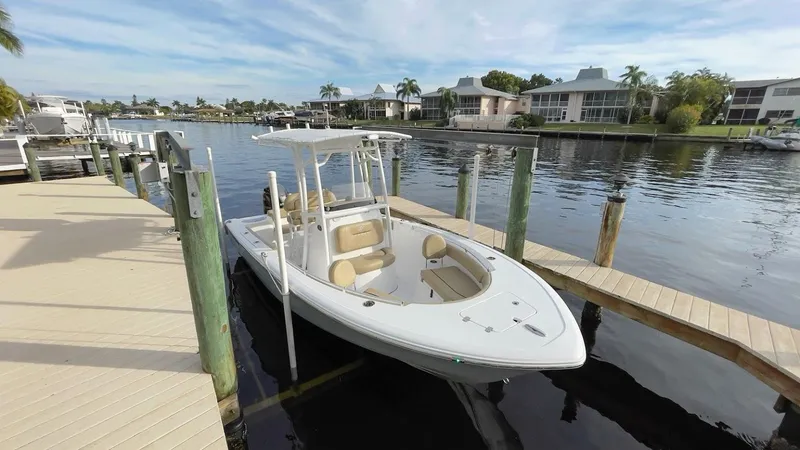 Slide: The Image of 2018 Sportsman Open 212 boat docked by waterfront homes. - 4