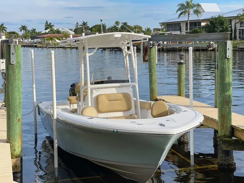 Slide: The Image of 2018 Sportsman Open 212 boat docked by waterfront homes. - 5