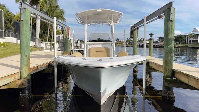 Slide: The Image of 2018 Sportsman Open 212 boat docked at a marina with palm trees. - 6