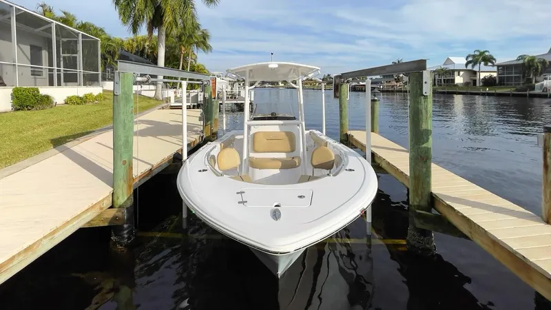 Slide: The Image of 2018 Sportsman Open 212 boat docked by a scenic waterfront. - 7