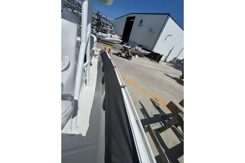 Slide: The Image of 2021 Glasstream 280 Pro-XS boat docked near a storage facility. - 12