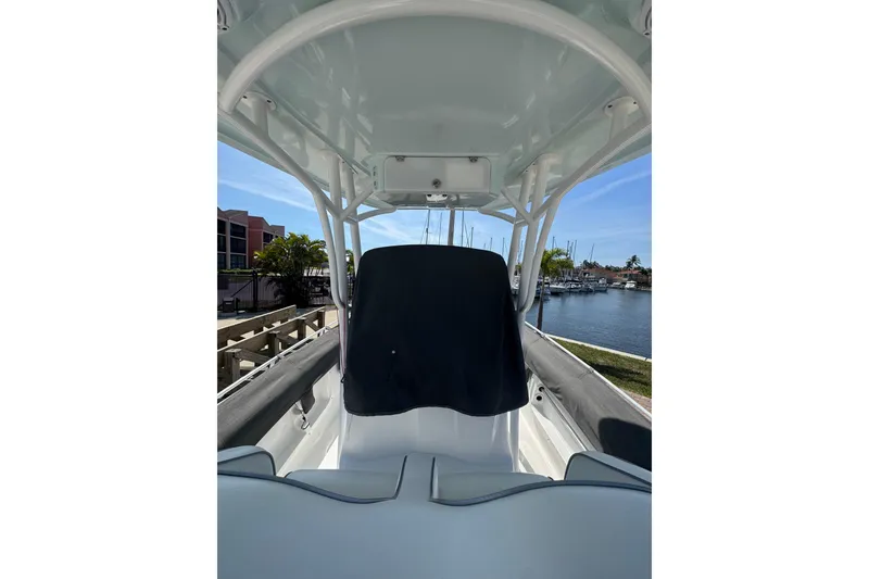 Slide: The Image of 2021 Glasstream 280 Pro-XS boat interior with covered console, docked by a marina. - 14