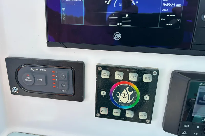 Slide: The Image of Control panel of a 2021 Glasstream 280 Pro-XS boat with active trim and lighting settings. - 19