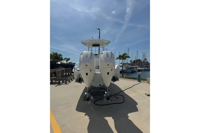 Slide: The Image of 2021 Glasstream 280 Pro-XS boat with dual engines docked at a marina. - 2