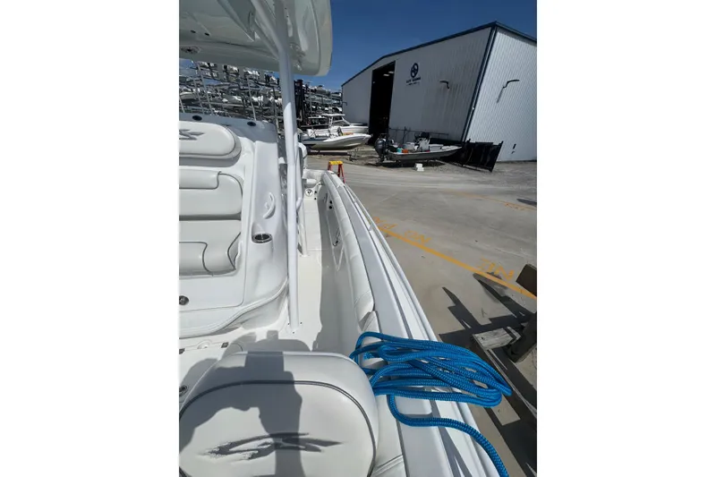 Slide: The Image of 2021 Glasstream 280 Pro-XS boat docked, featuring sleek white interior and blue rope. - 4