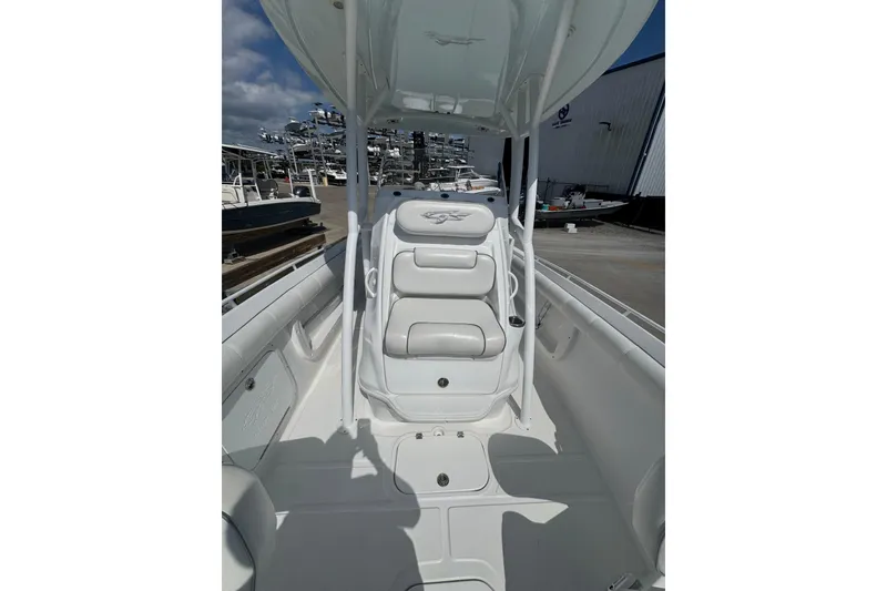 Slide: The Image of 2021 Glasstream 280 Pro-XS boat interior with seating and canopy, docked at a marina. - 5