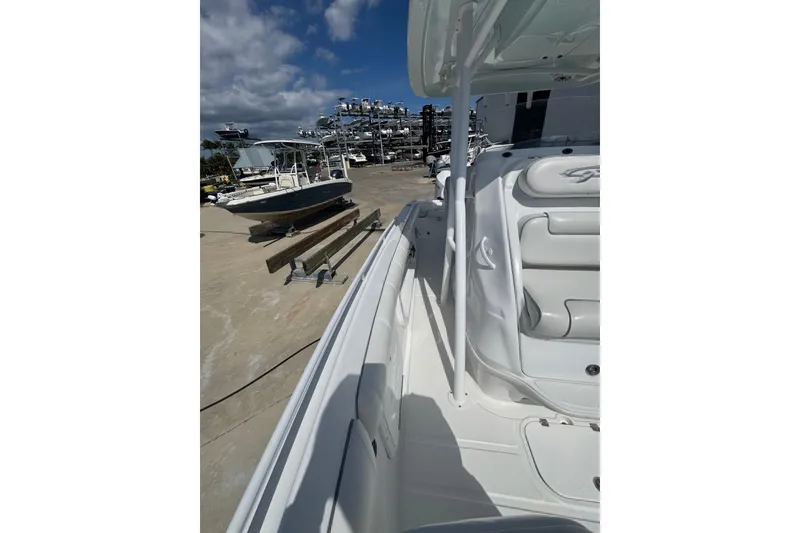 Slide: The Image of 2021 Glasstream 280 Pro-XS boat docked, showcasing sleek white interior and seating. - 6
