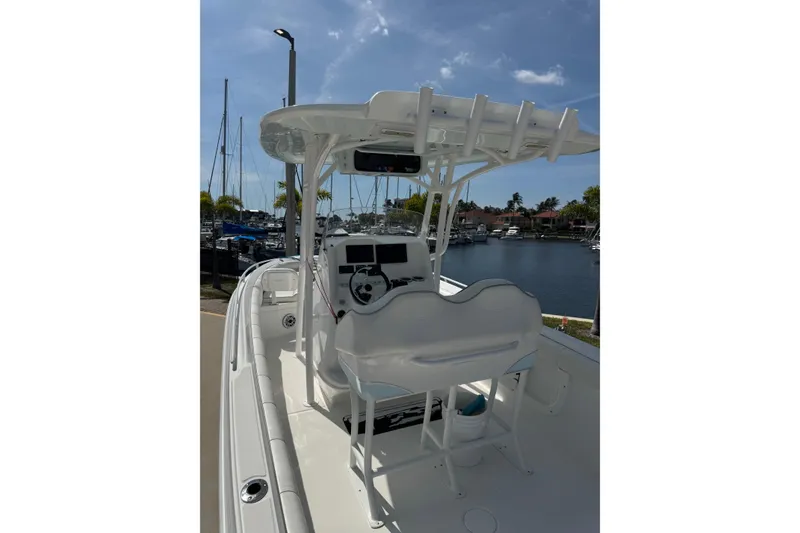 Slide: The Image of 2021 Glasstream 280 Pro-XS boat with helm station, docked at marina under clear sky. - 7